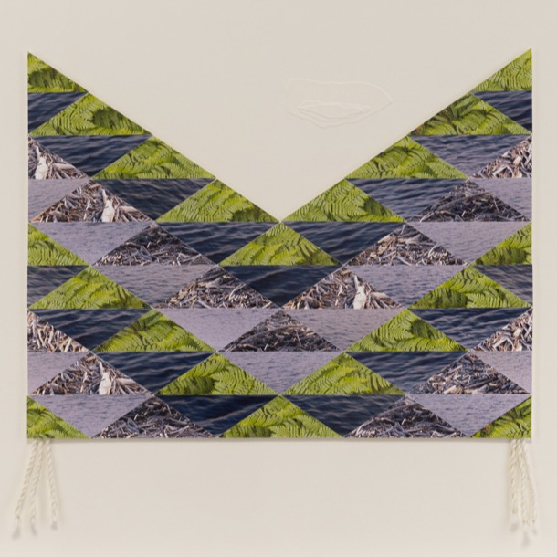 A photoprint quilt by Epiphany Couch, with photos of the land, water, and driftwood cut up and quilted together in a distinct pattern. 