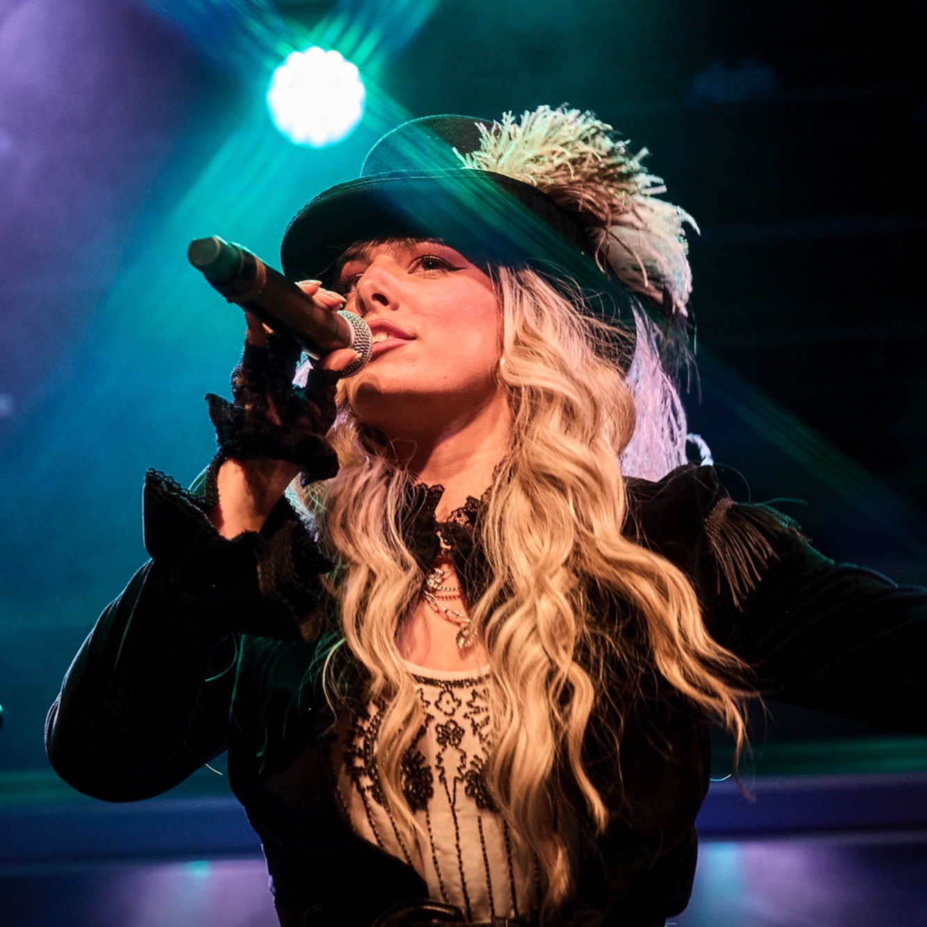 a person singing in to a microphone