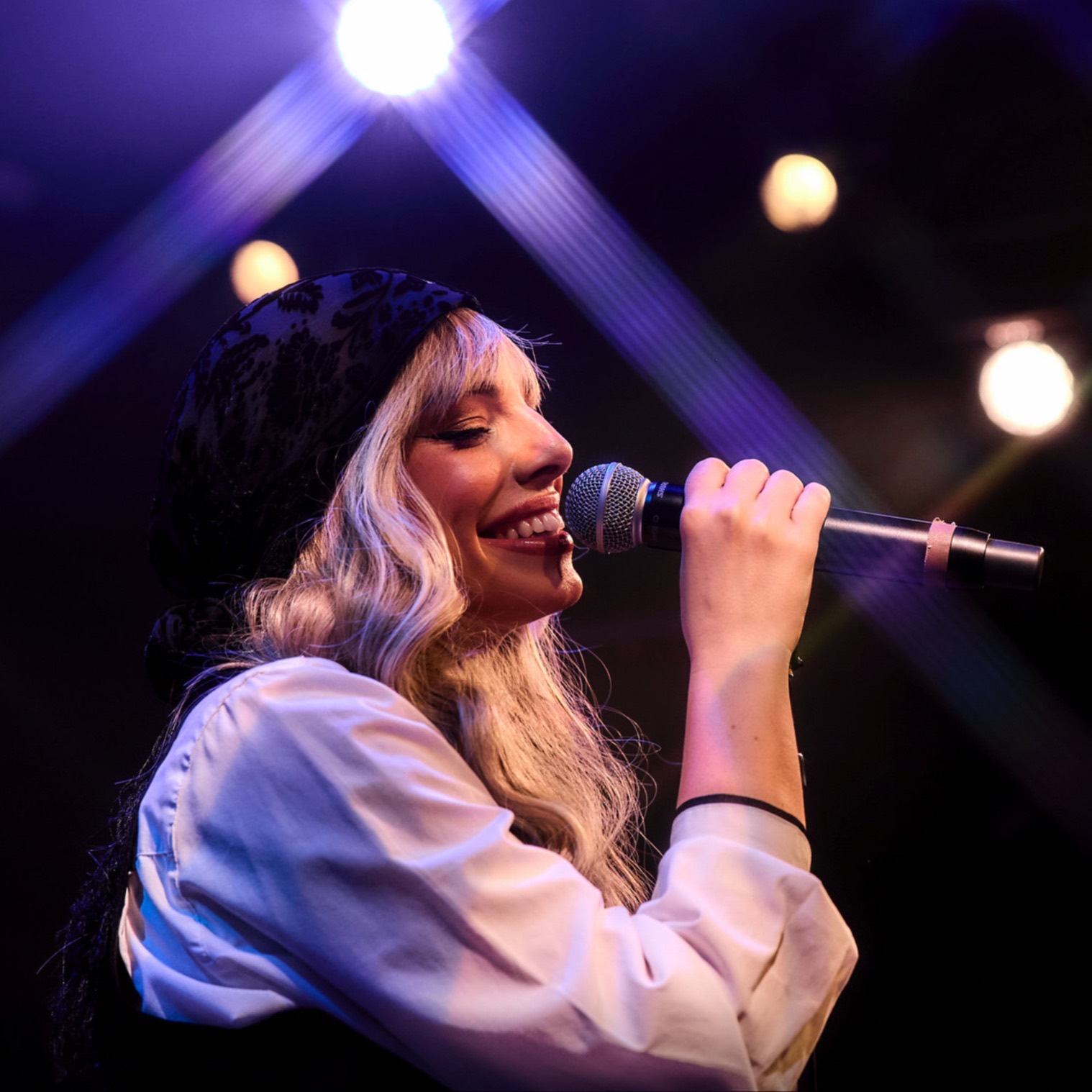 a person singing into a microphone