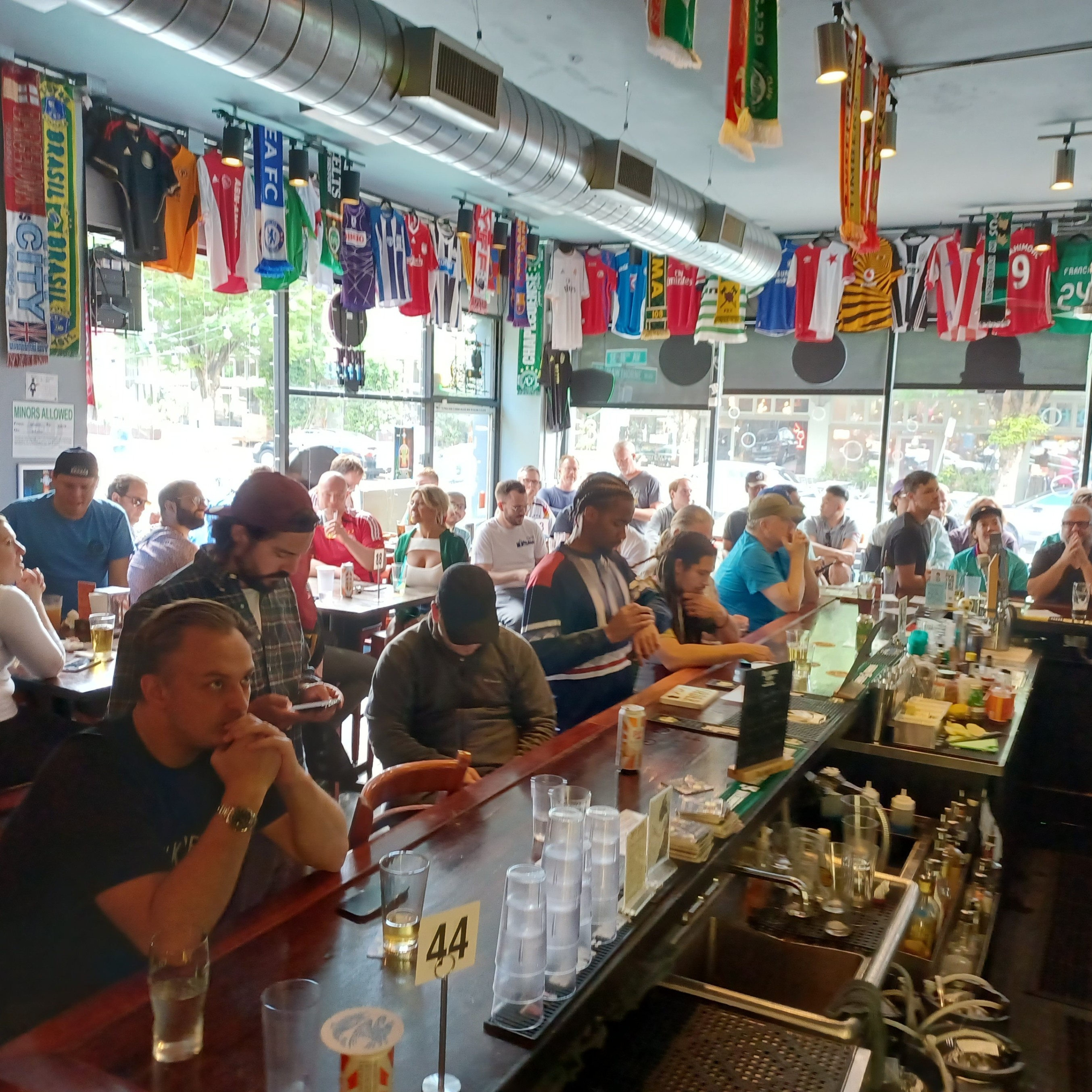 people in a bar watching sports
