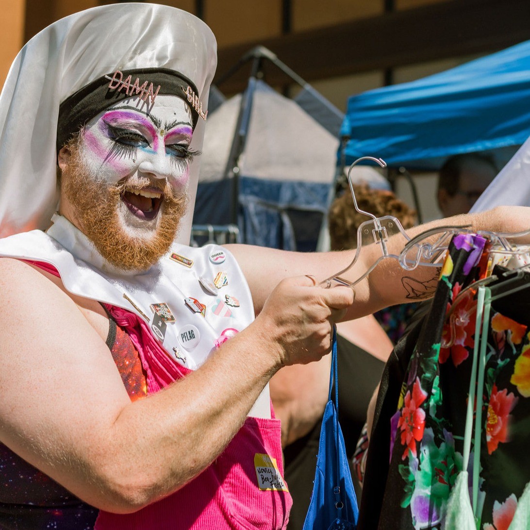 a drag performer hanging up clothes