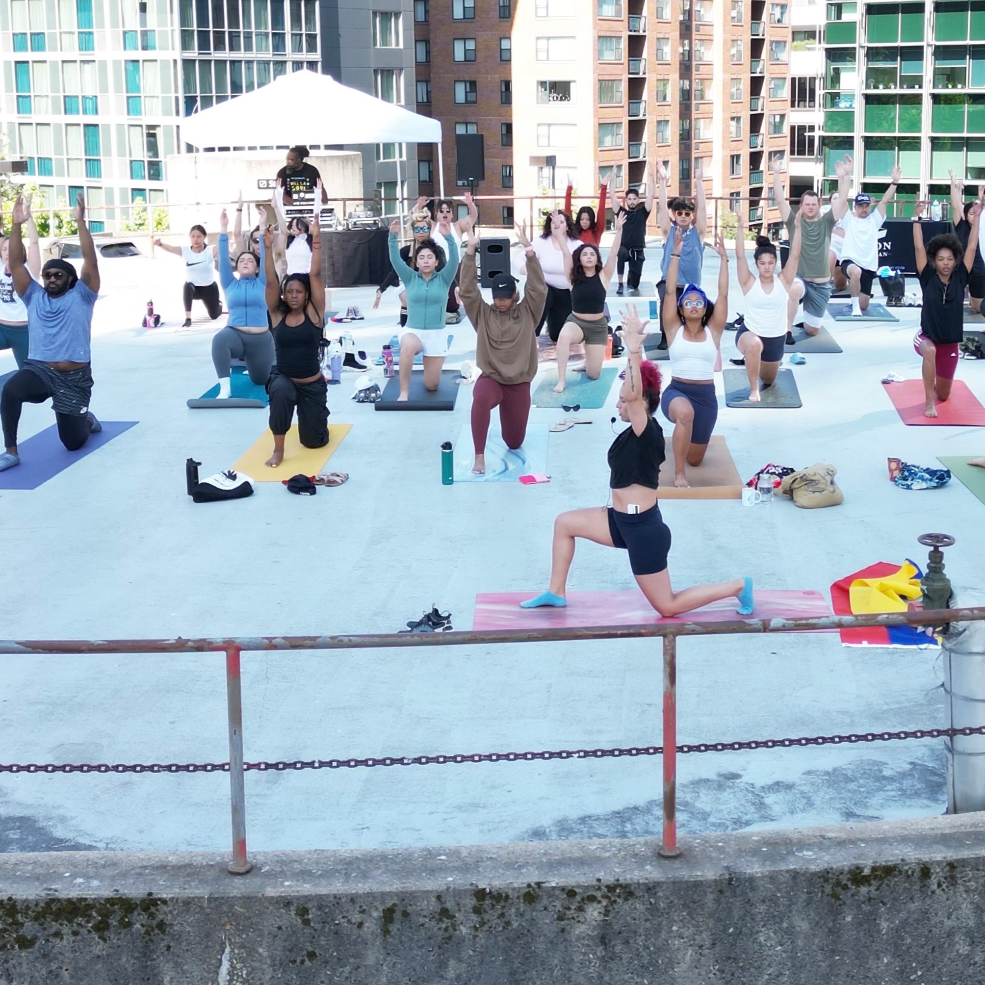 image of people doing yoga in a city 