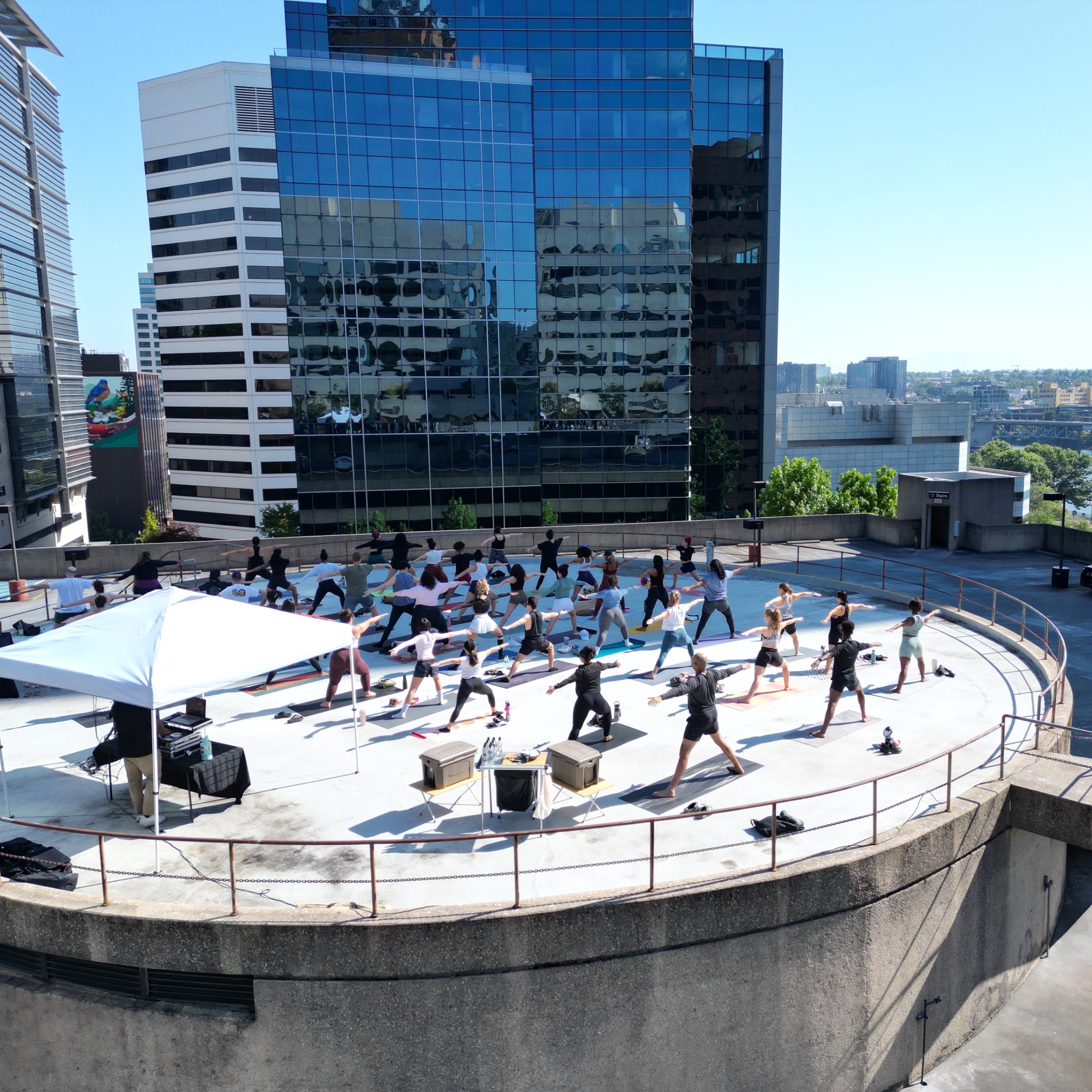 image of people doing yoga on a rooftop