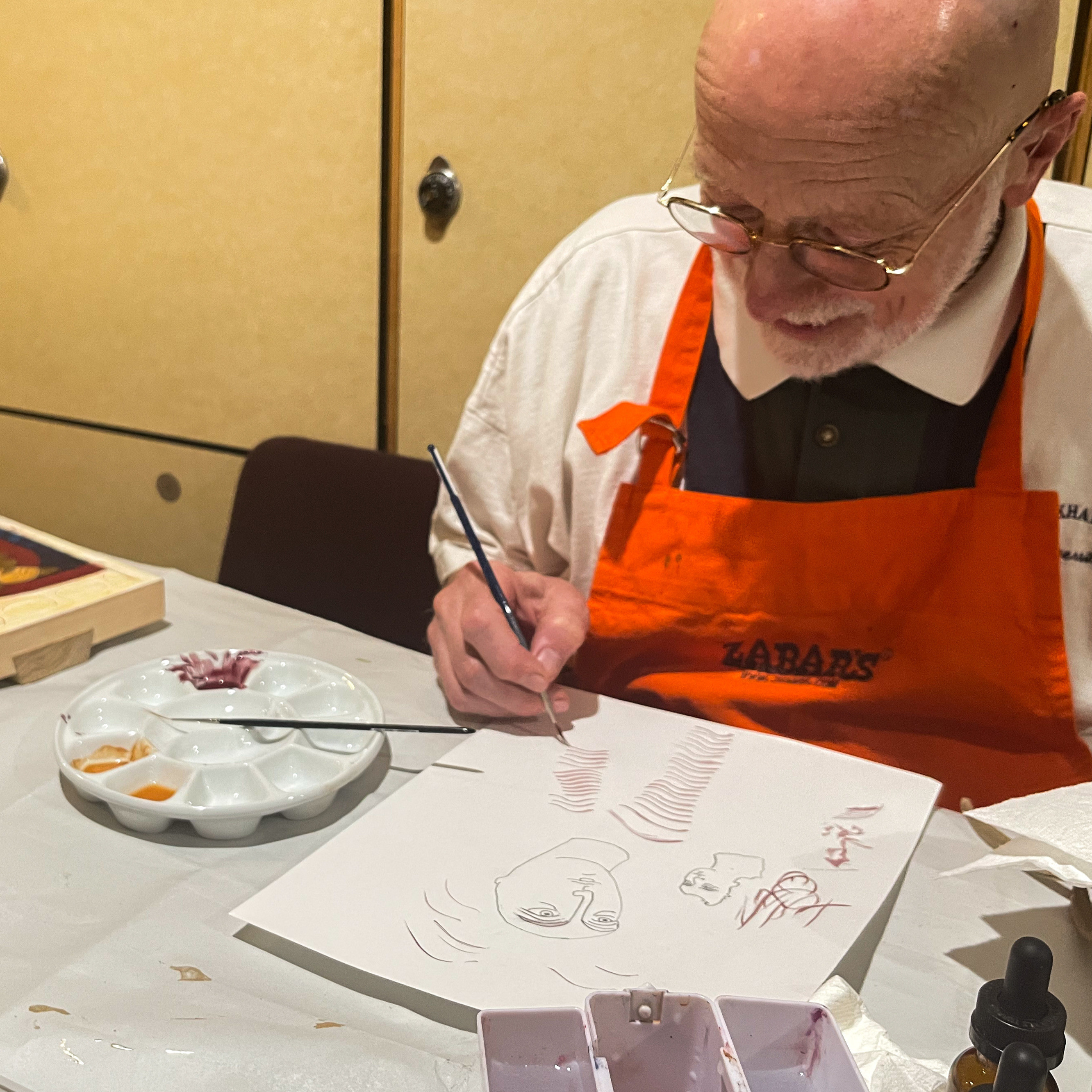 man painting on paper