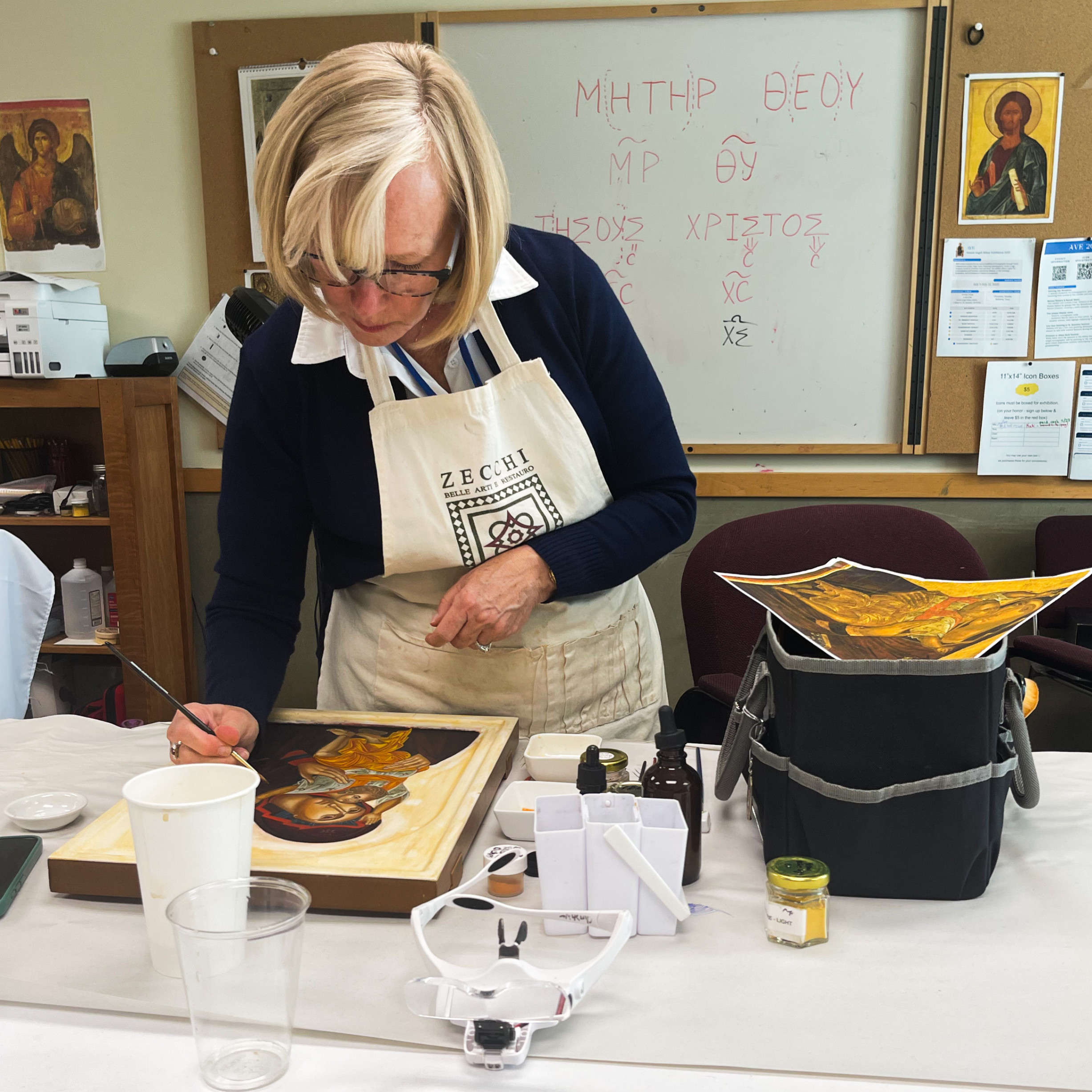 woman painting an image of mary and child