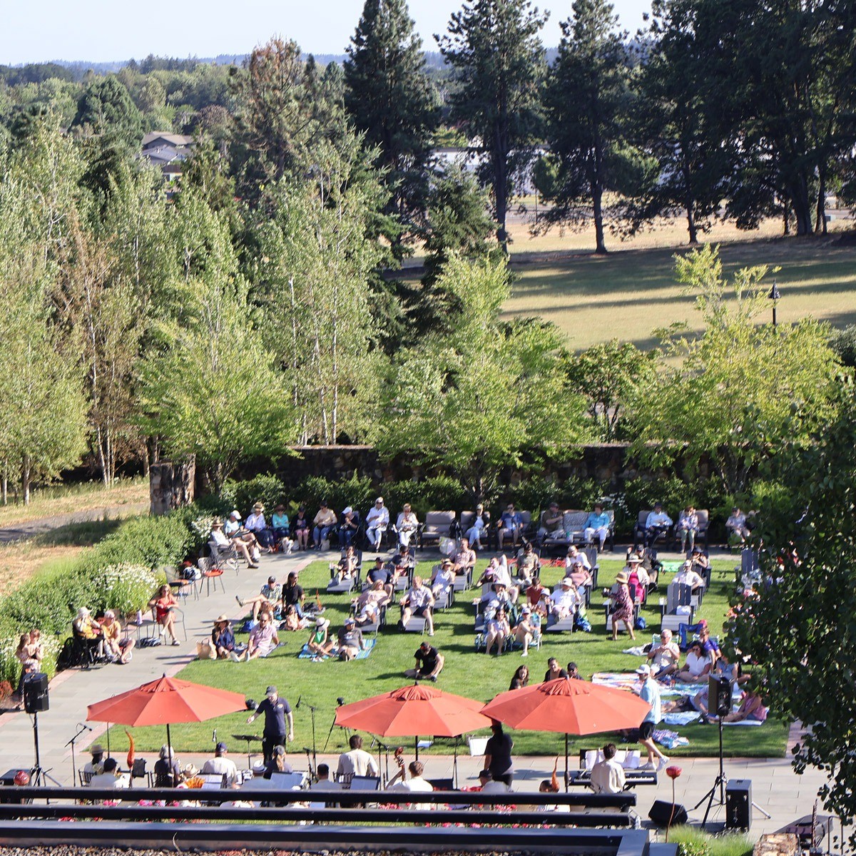 A view of the Estate Garden with guests on the lawn enjoying the musical performance.