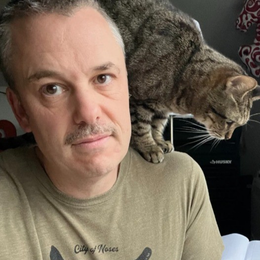 image of a man with a cat on his sholders