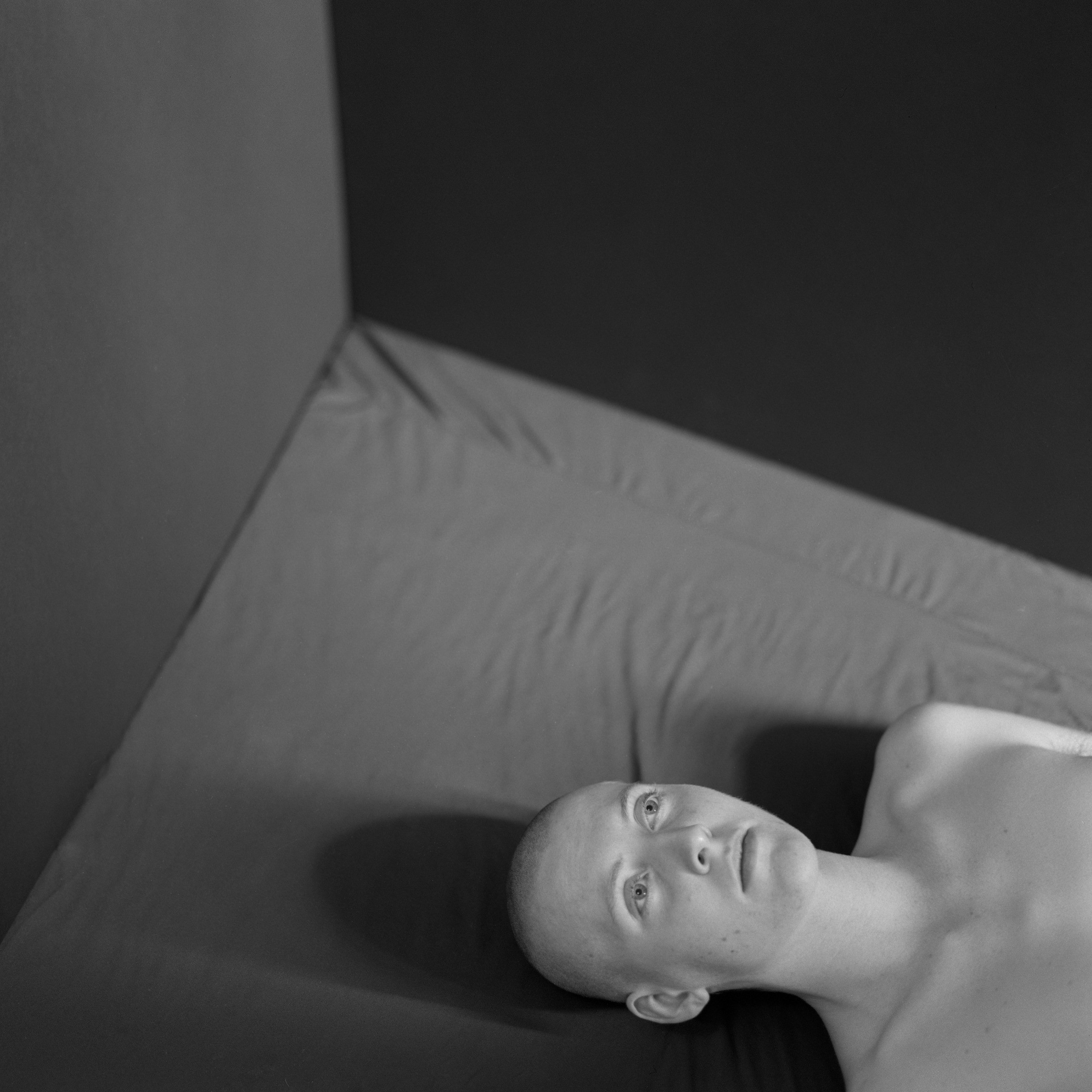 a person lying in a black box