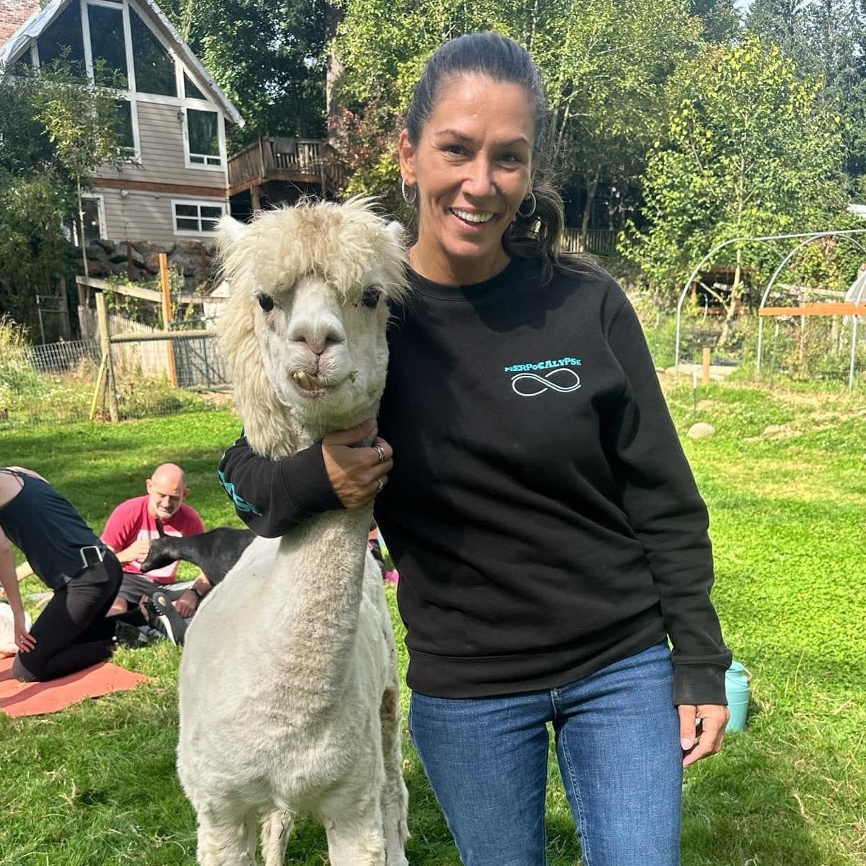 a person hugging an alpaca