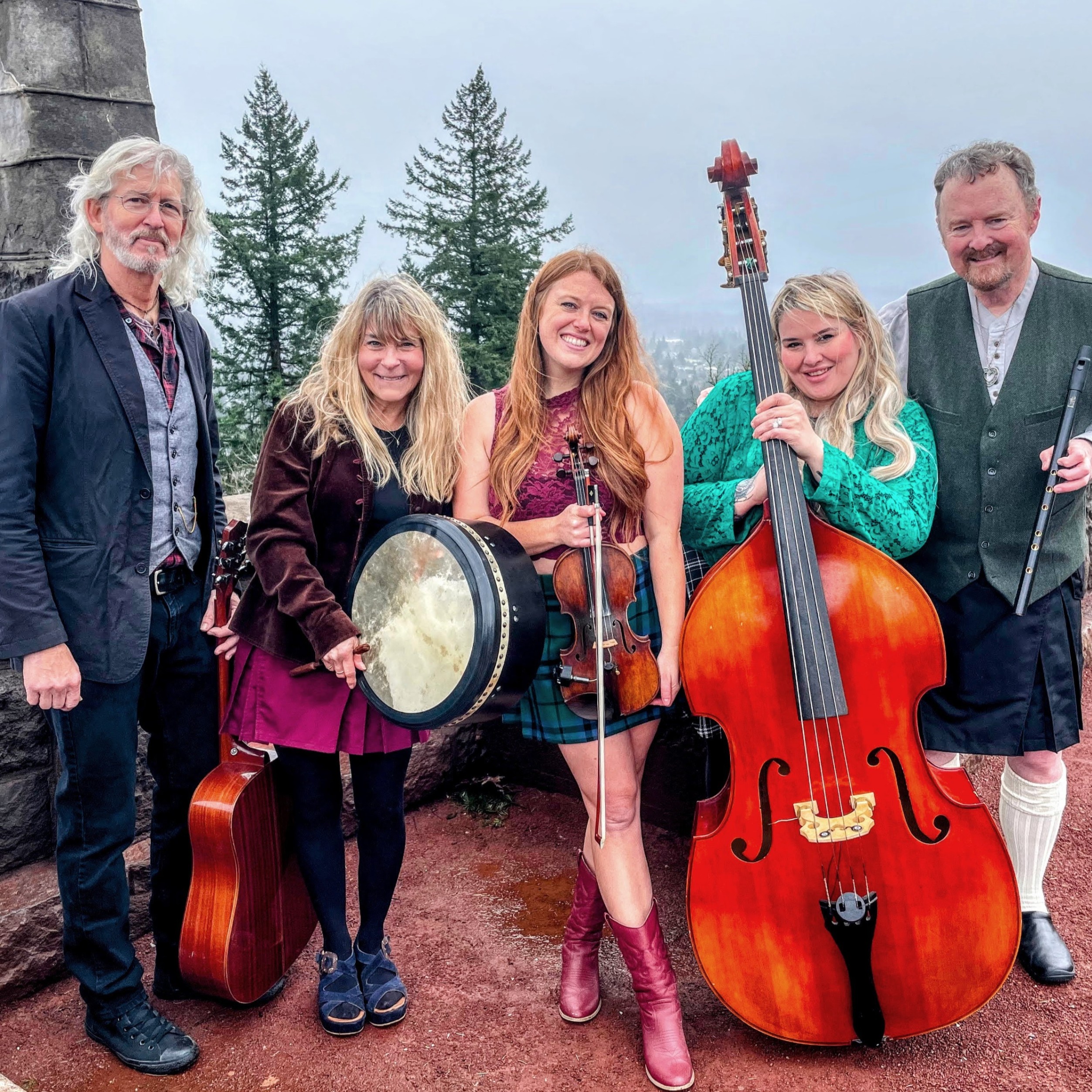 a celtic band poses with their instruments