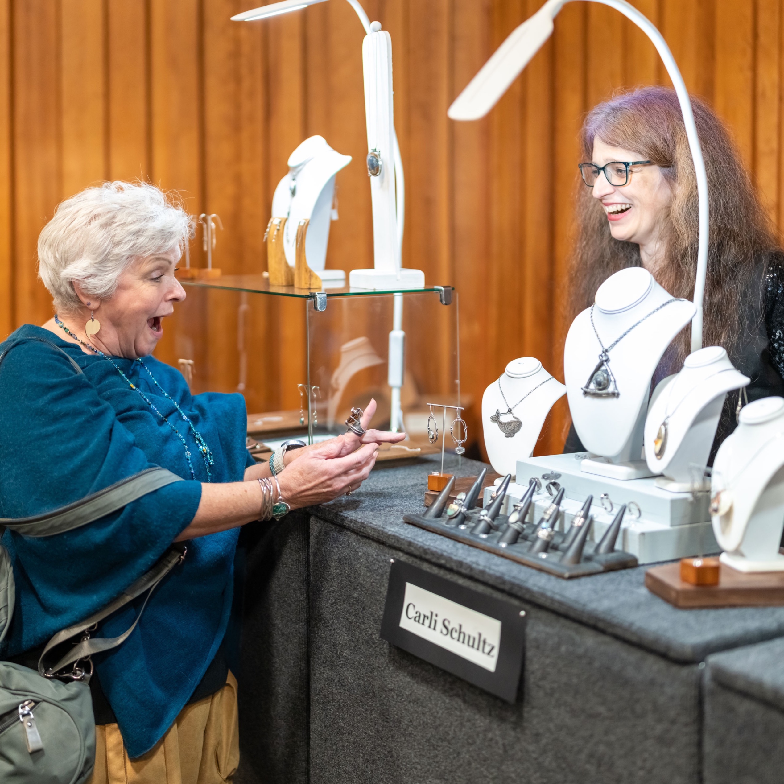 a woman shopping at a jewelry booth
