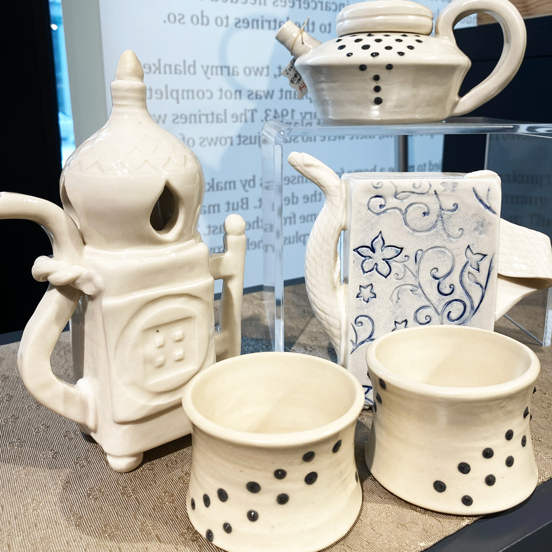white and blue ceramic teapots and cups