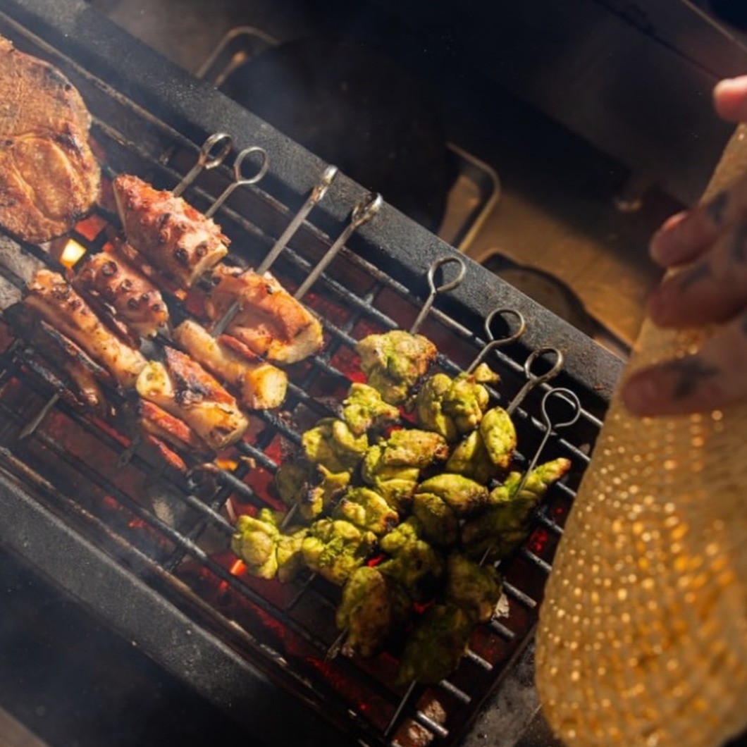 meat on skewers being grilled 