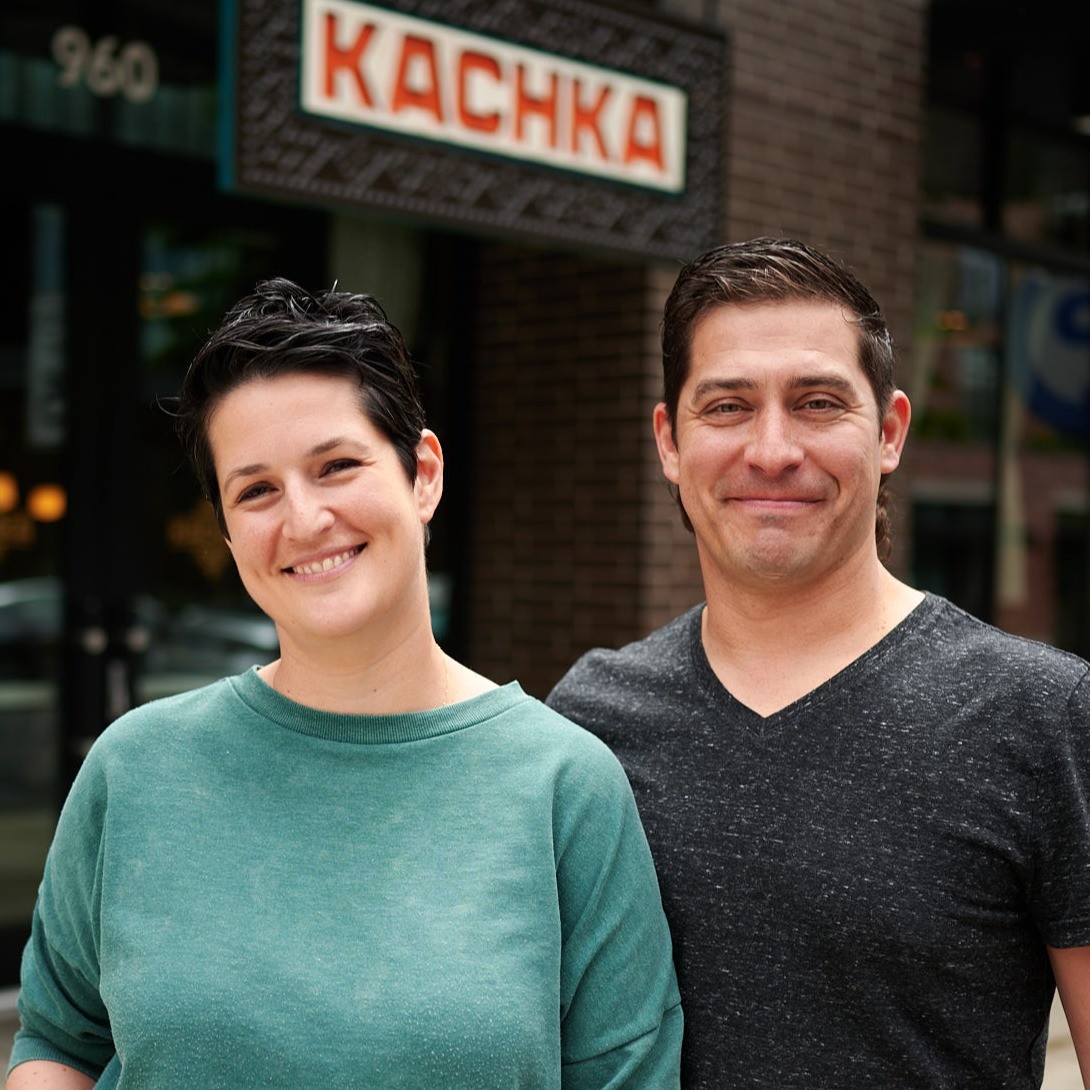 two people smiling at the camera