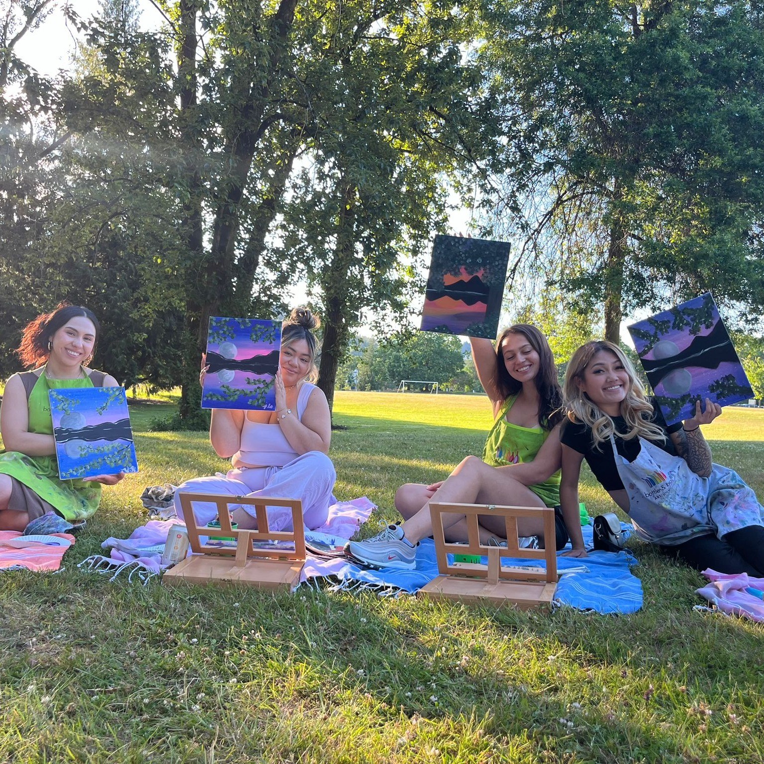 people showing off the paintings they just made