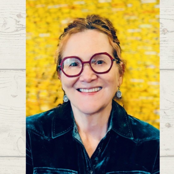 headshot of a person in glasses