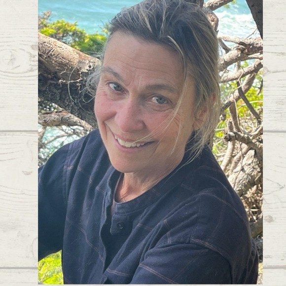 a woman sitting among tree branches