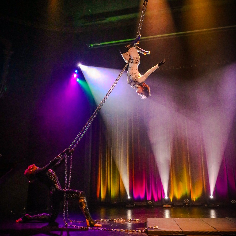people performing a trapeze act on stage