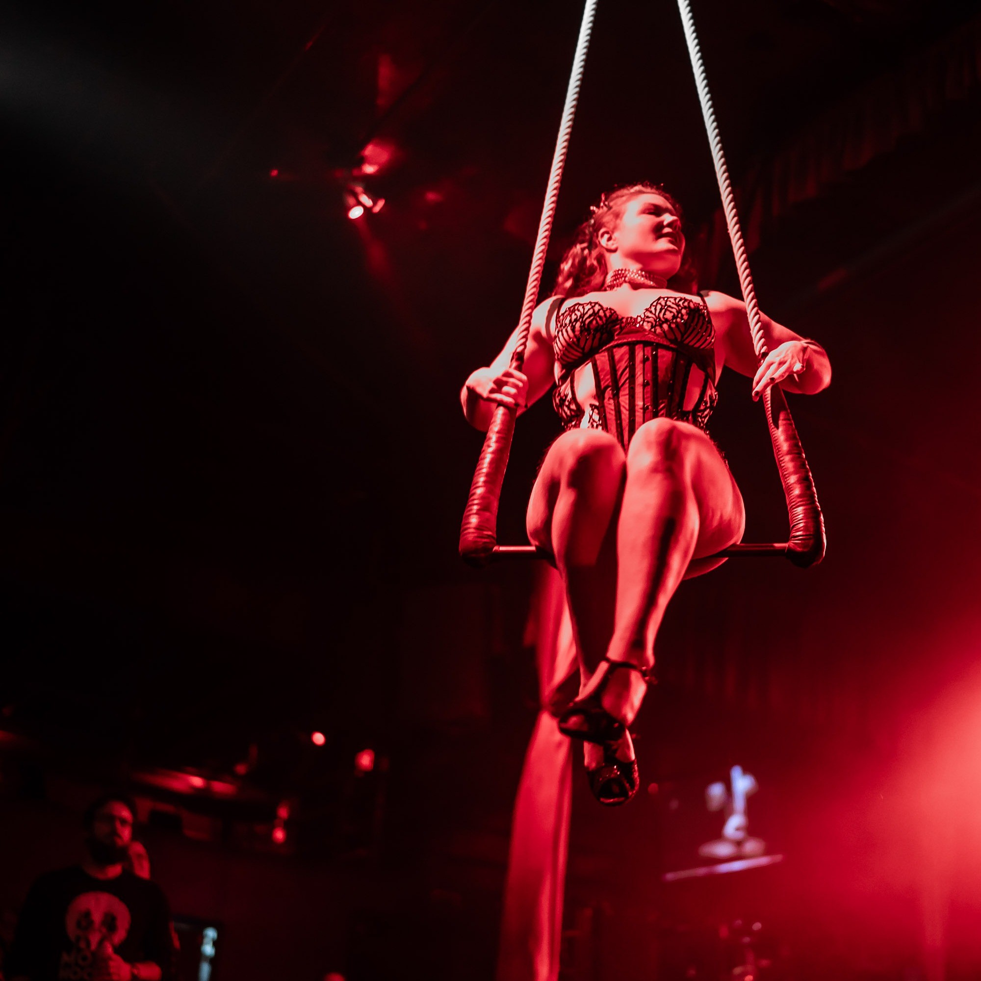 a person performs on a swing