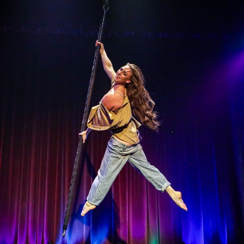 a person swinging on a pole in the air