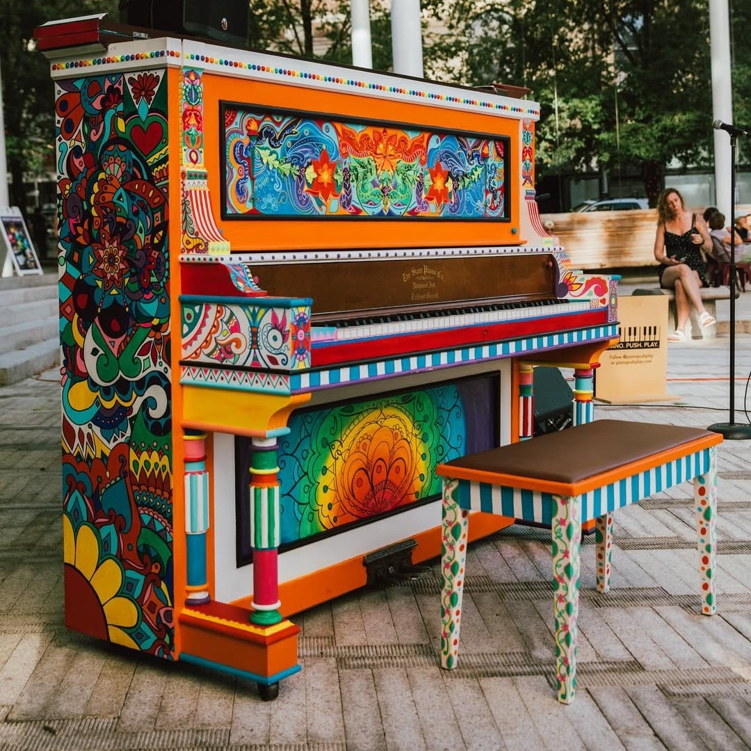 an artfully painted piano sitting in a public square