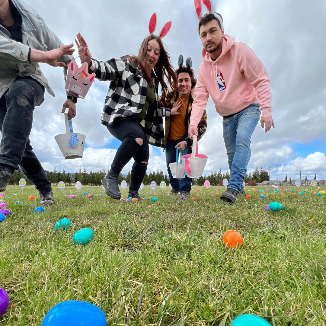 people in bunny ears hunting for Easter eggs