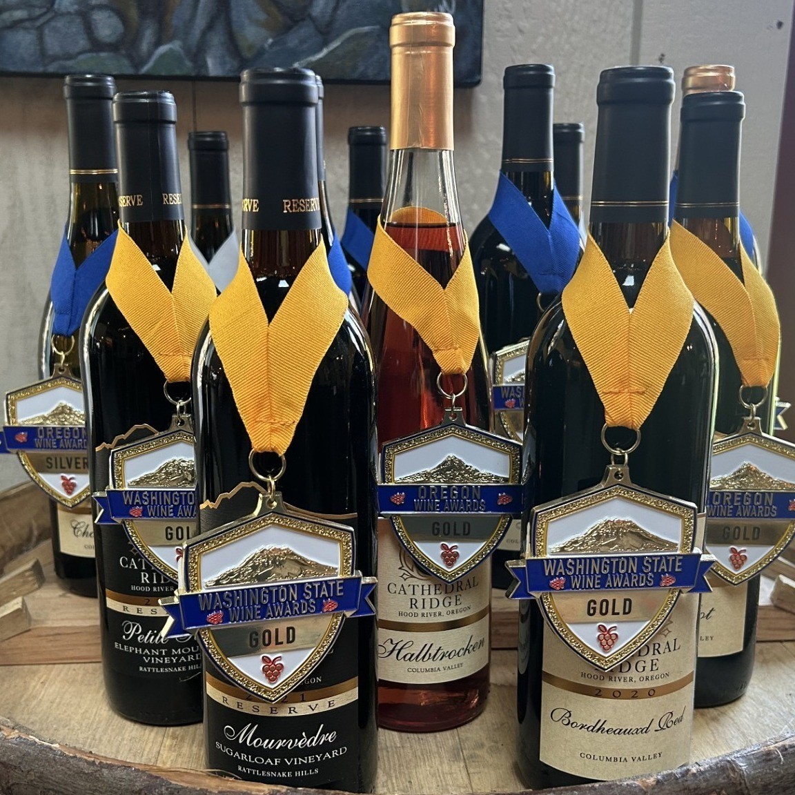 wine bottles with award ribbons hanging on the necks