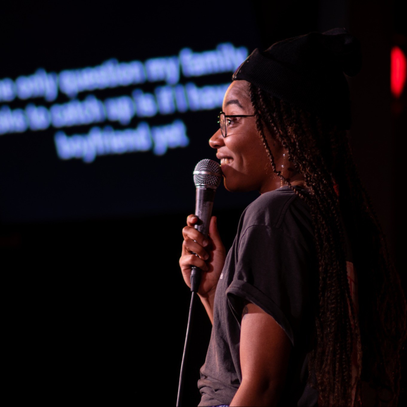 person on stage speaking into a microphone