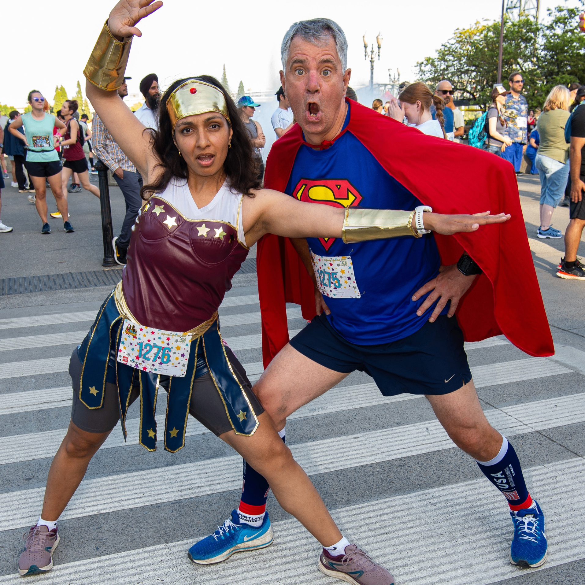 runners in super hero costumes