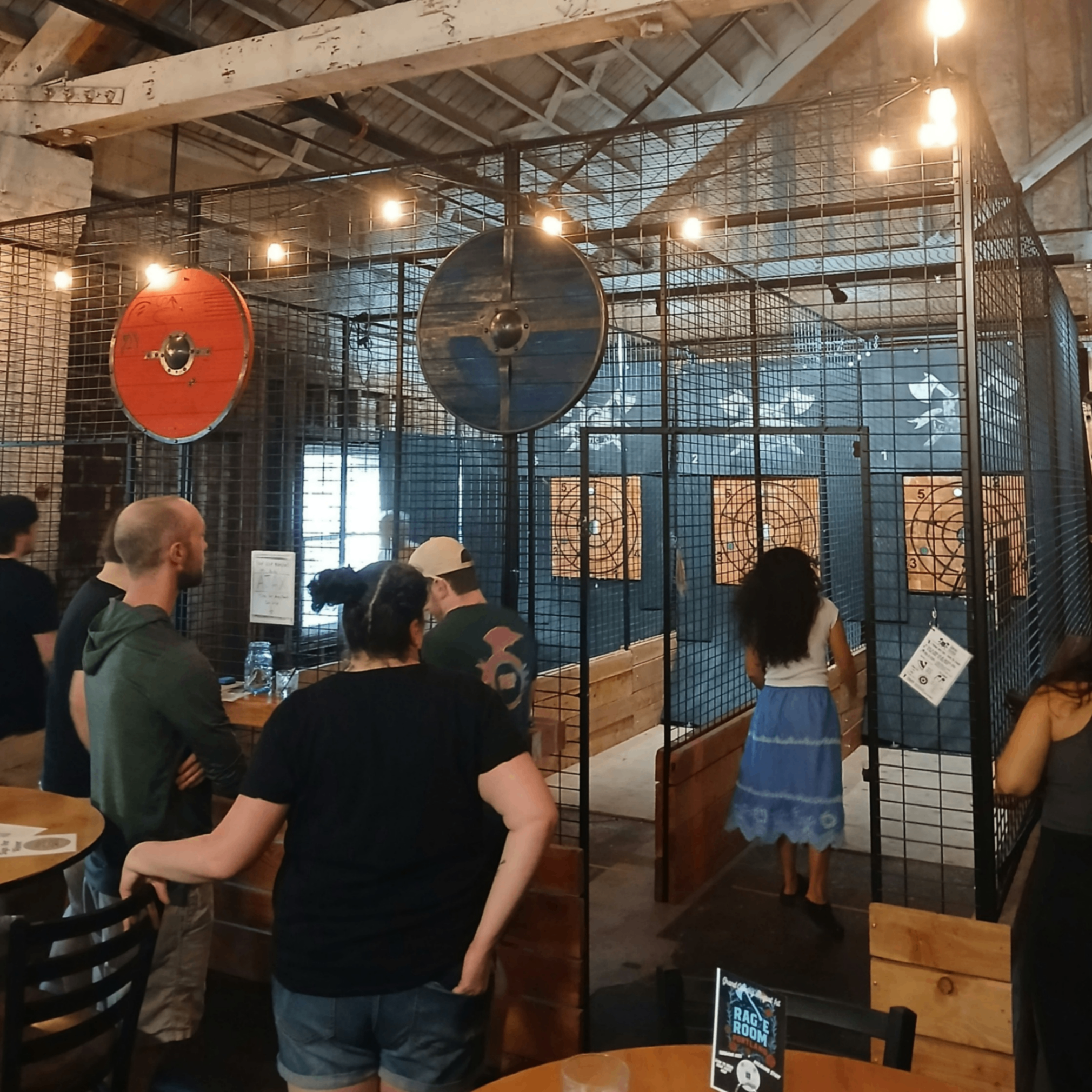 people lined up to play bar games 