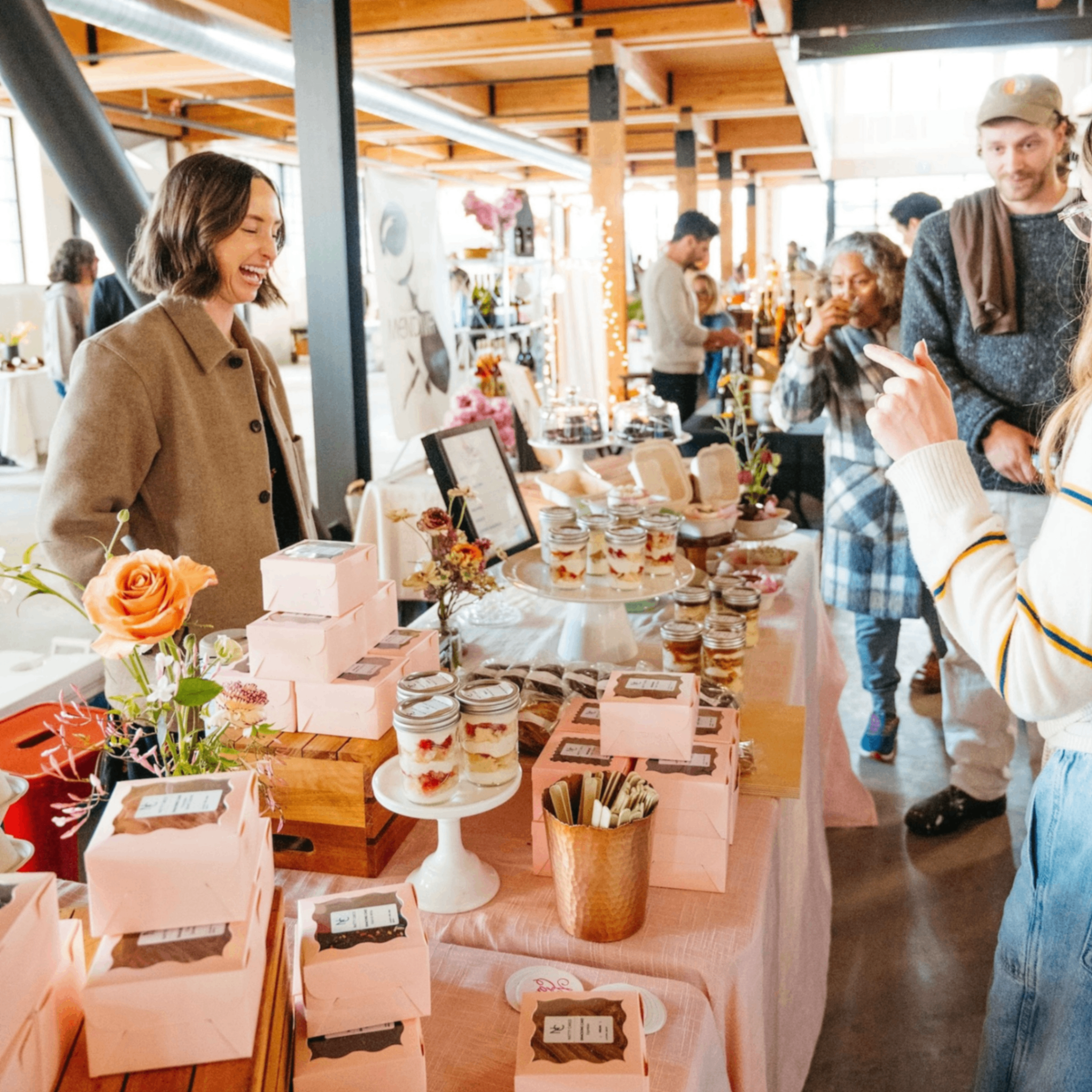 people shopping at a booth at a market