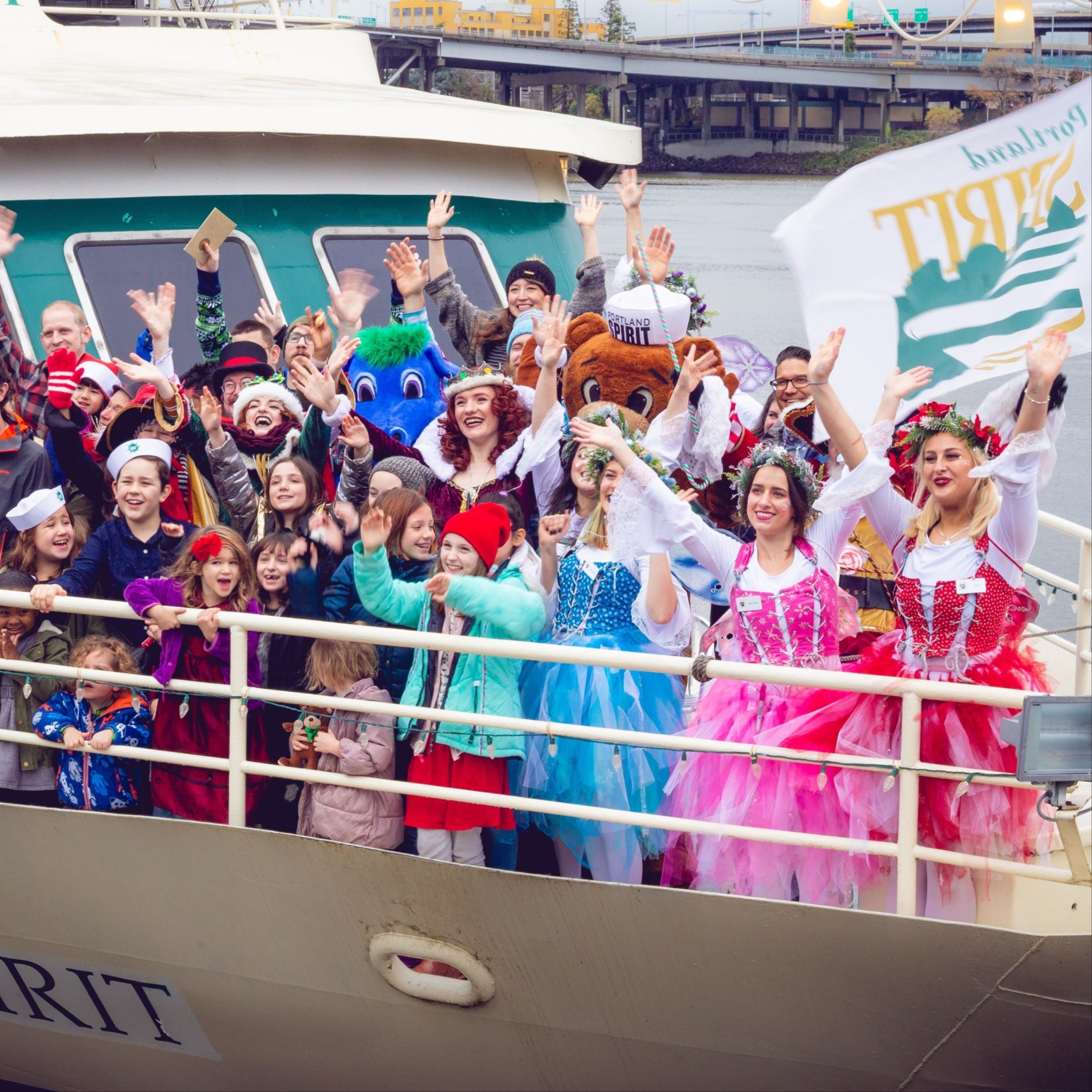 a crowd of people waving from the rail of a large ship