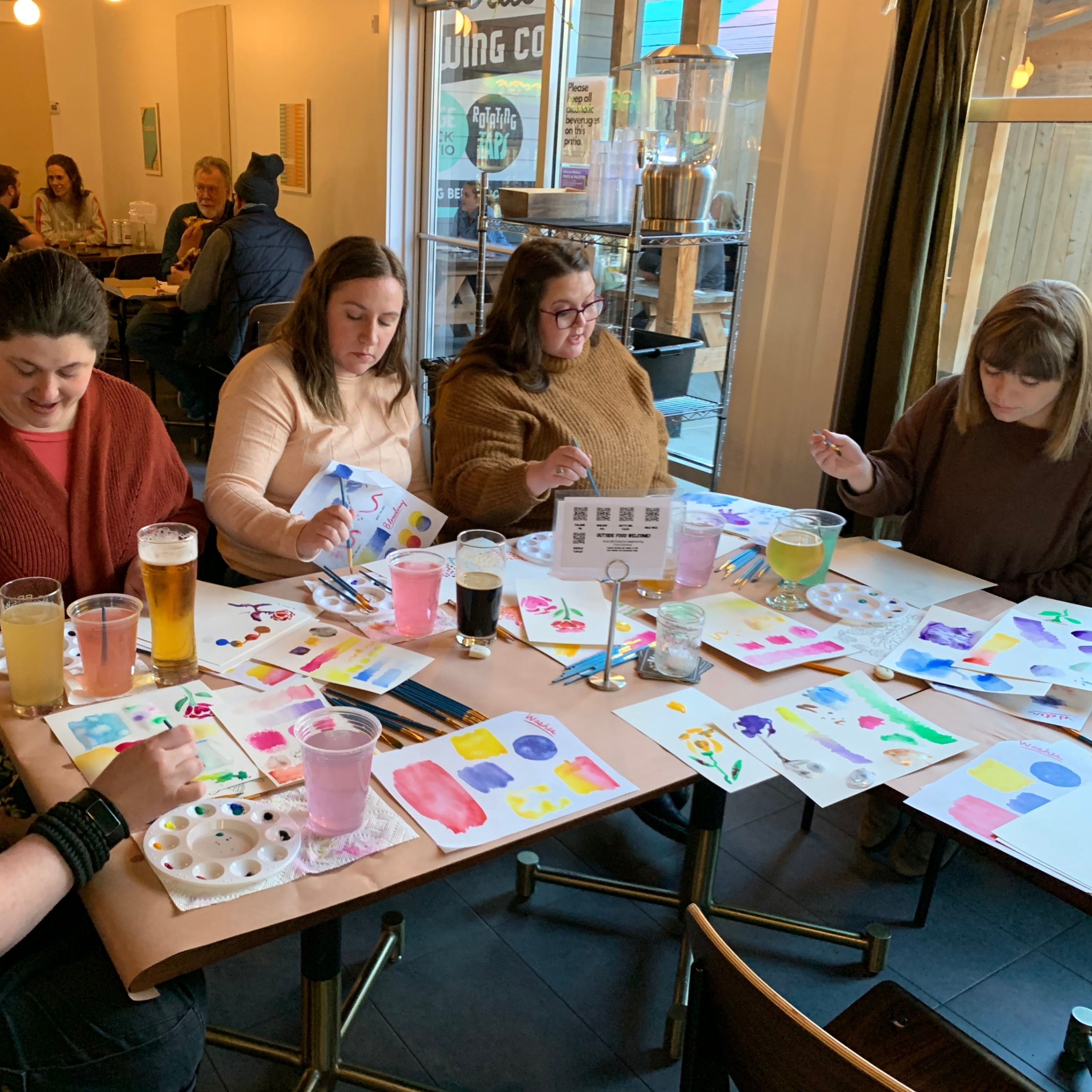people painting at several tables