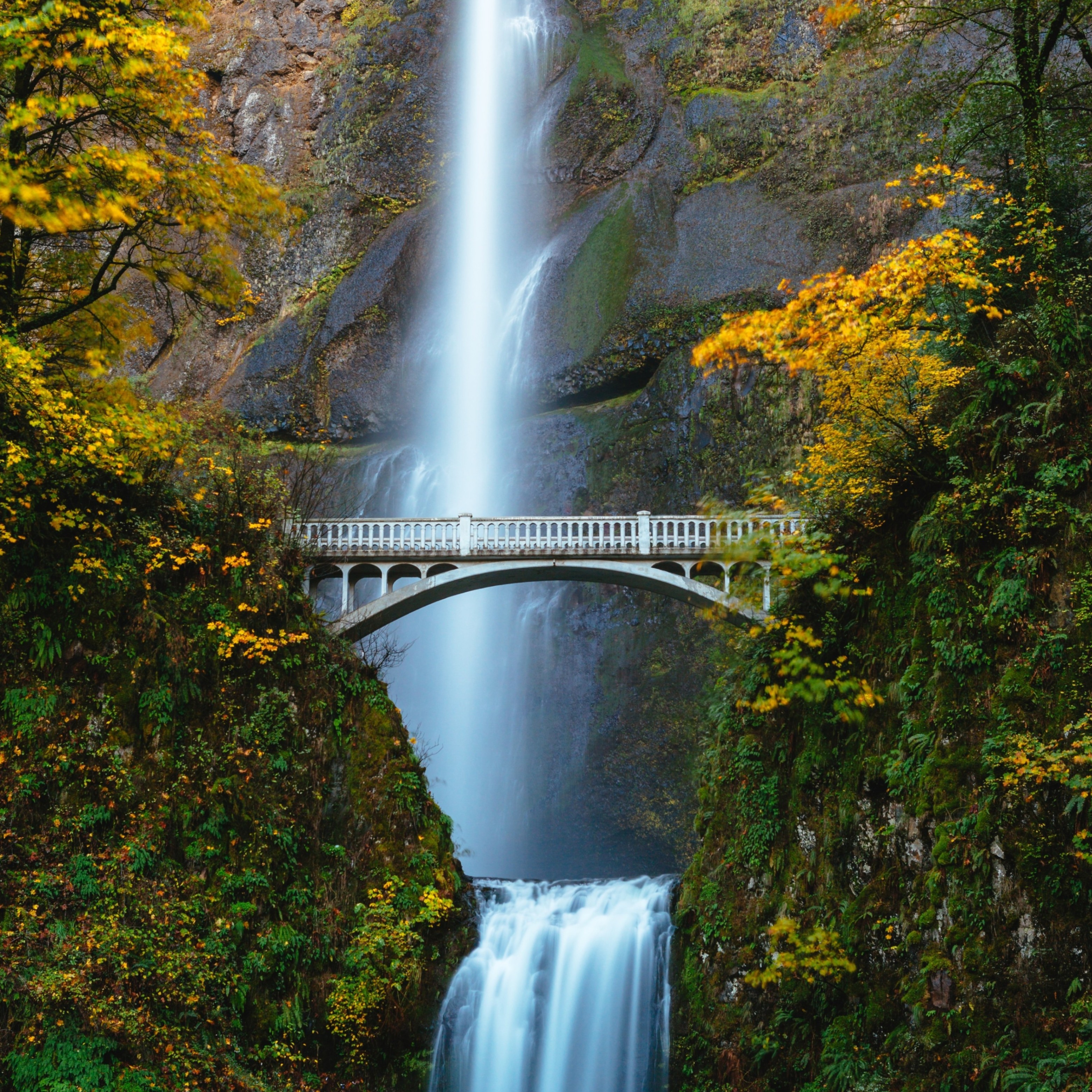 a bridge spanning a large waterfall
