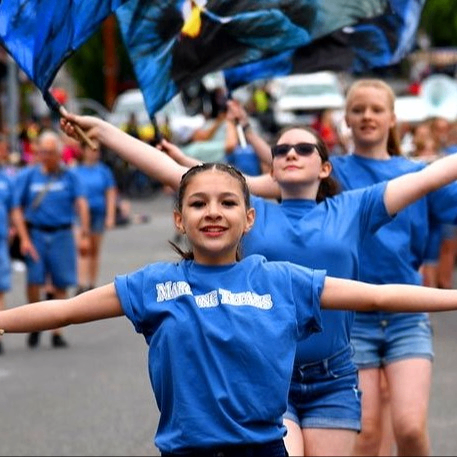 kids waving flags in a parade