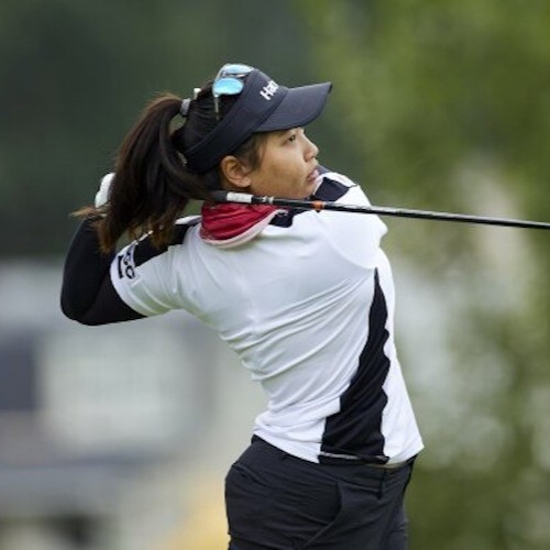 a woman after hitting a golf ball