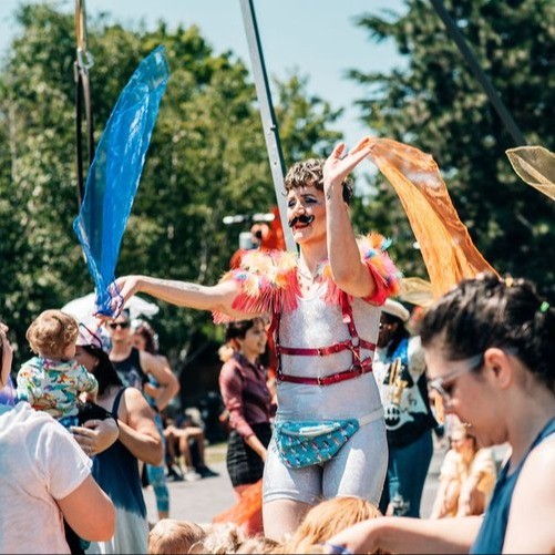 pride performer waving scarves