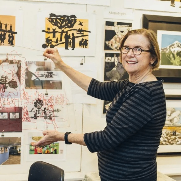 a person holding up their art