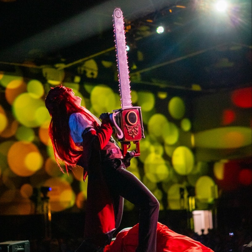 person in cosplay on stage lipsincing