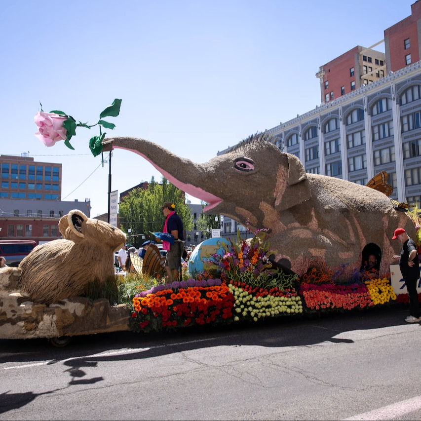 an elaborate parade float featuring a mouse and an elephant