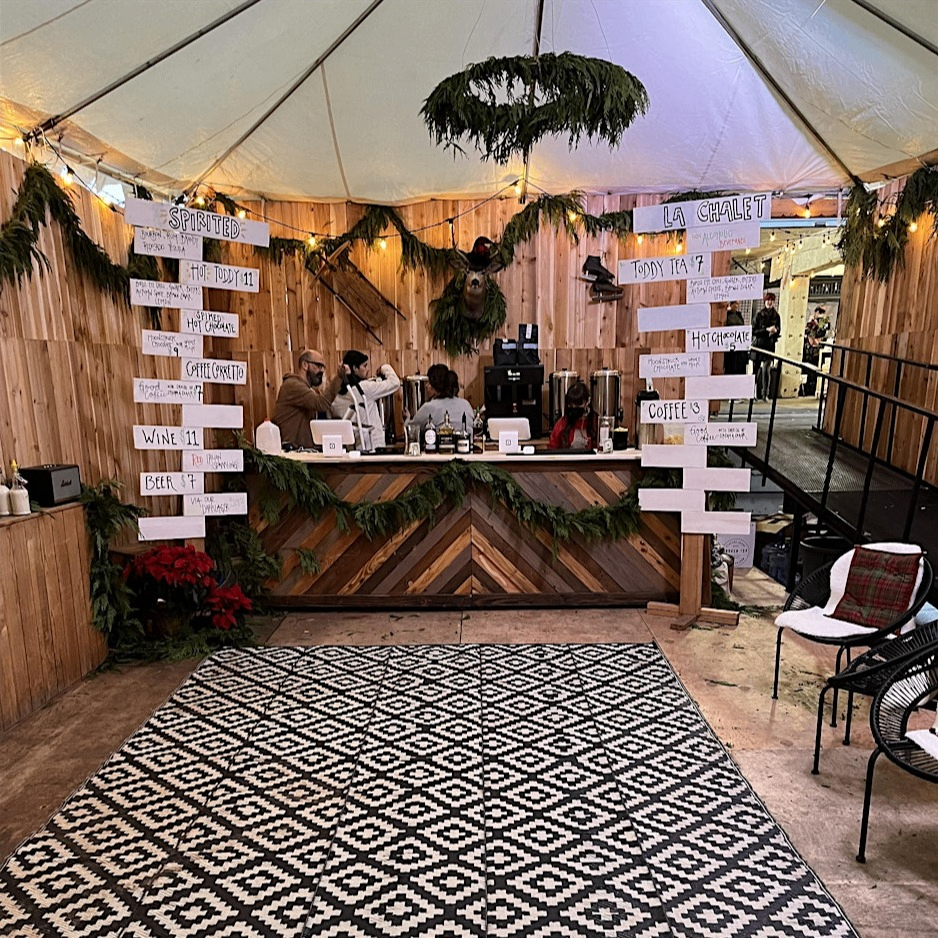 a coffee booth decorated in festive garlands