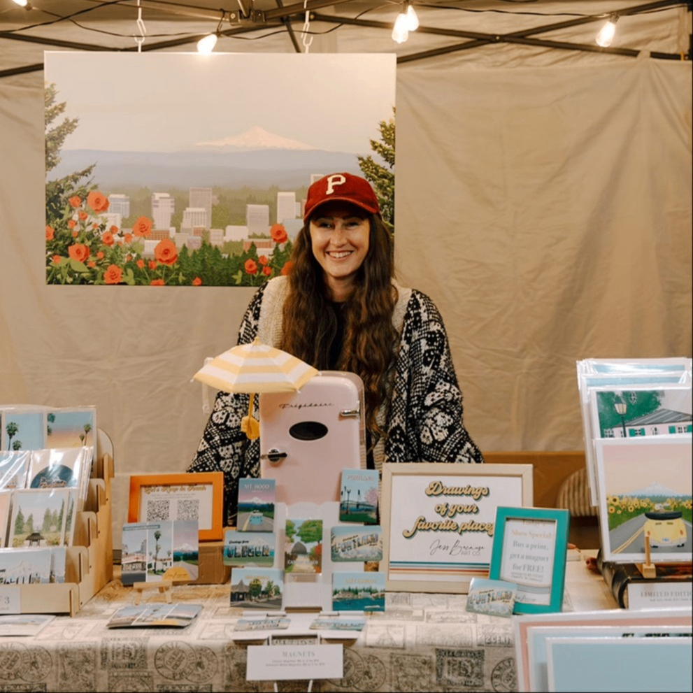 a person selling art at an outdoor market