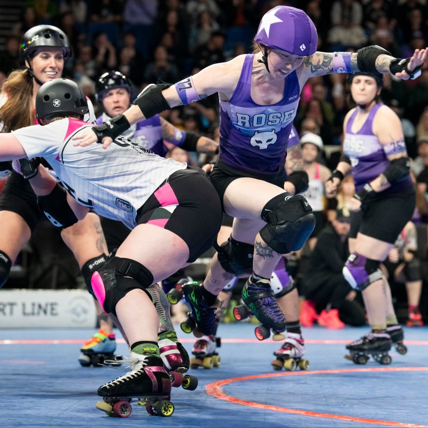 teams compete in a roller derby bout